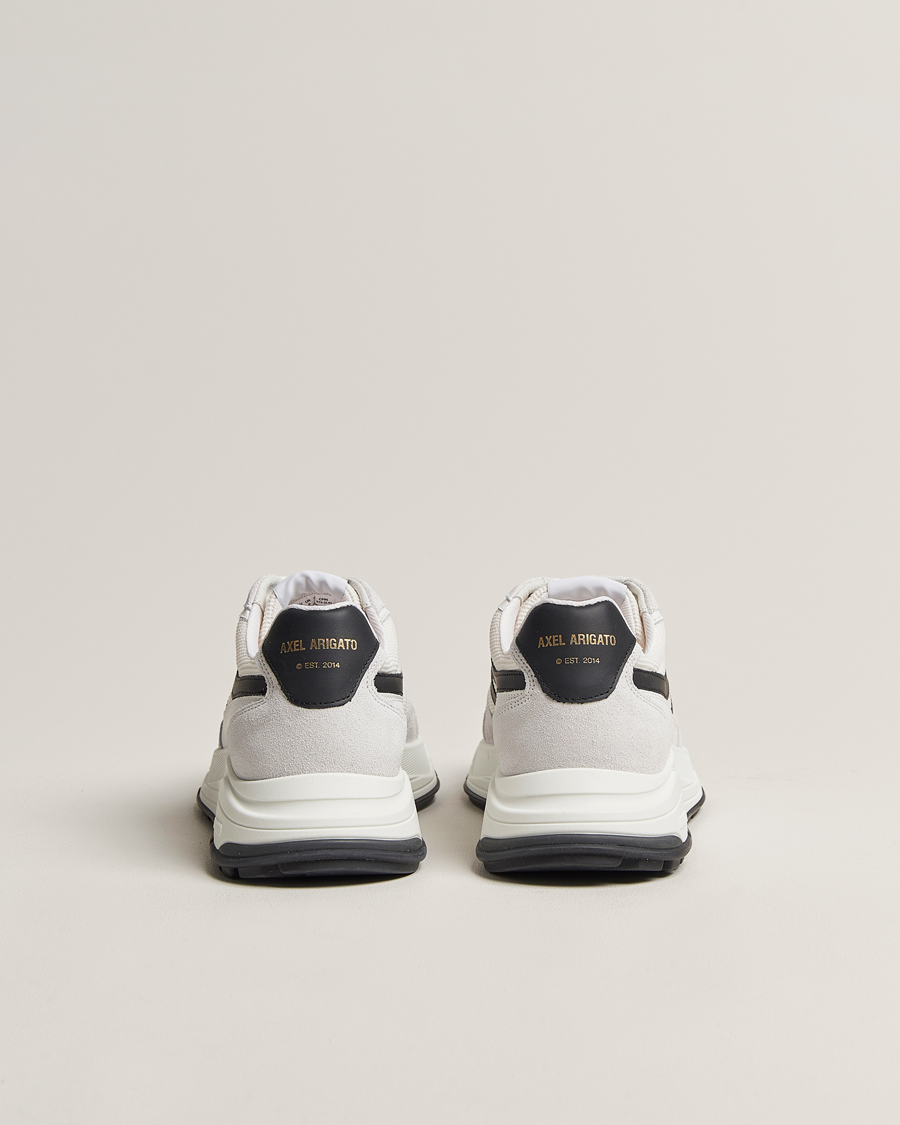 black axel arigato trainers